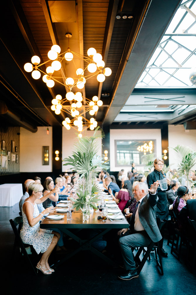 Guests seated at Long Table at 501 Union Wedding
