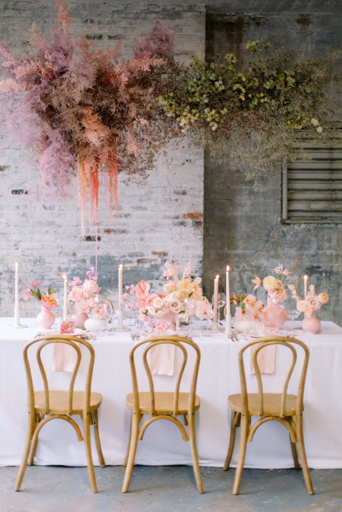 Reception table set up with hanging floral installation