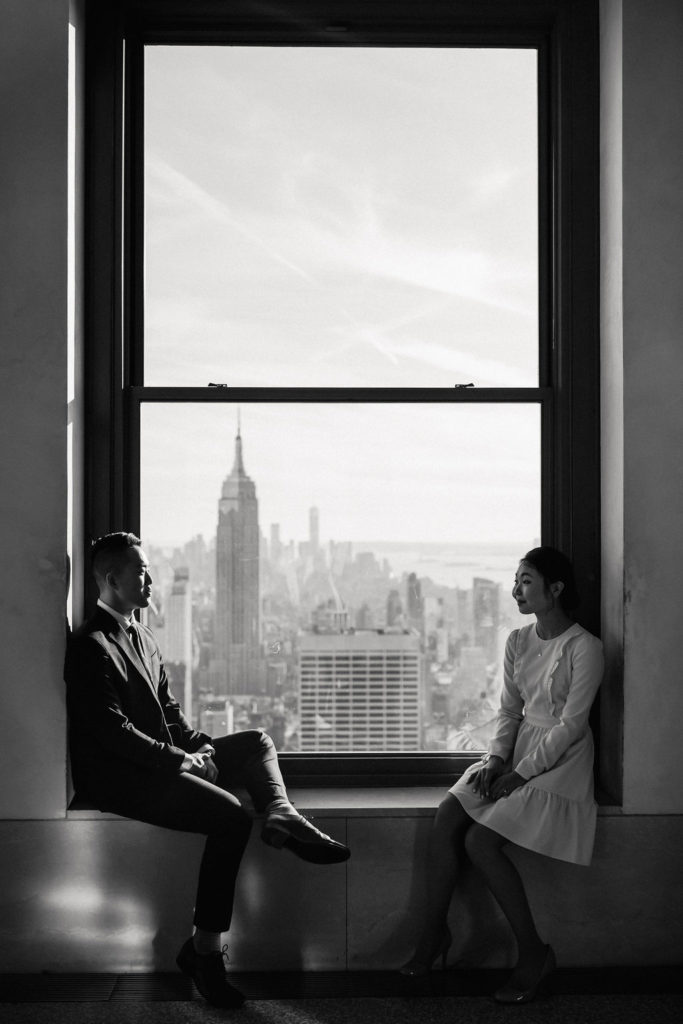 Couple gazing at each other with views of the Empire State