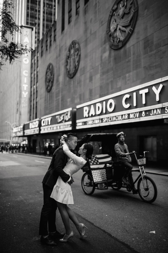 Couple at Radio City with a Trishaw in the bavkground