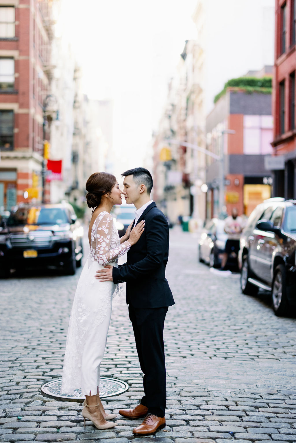 Couple Kissing on cobblestone streets at SOHO