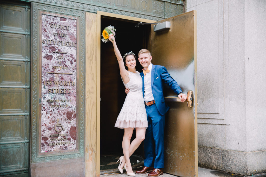 Couple exiting the Office of the City Clerk |  Rebecca Ou Photography | NYC City Hall Weddings
