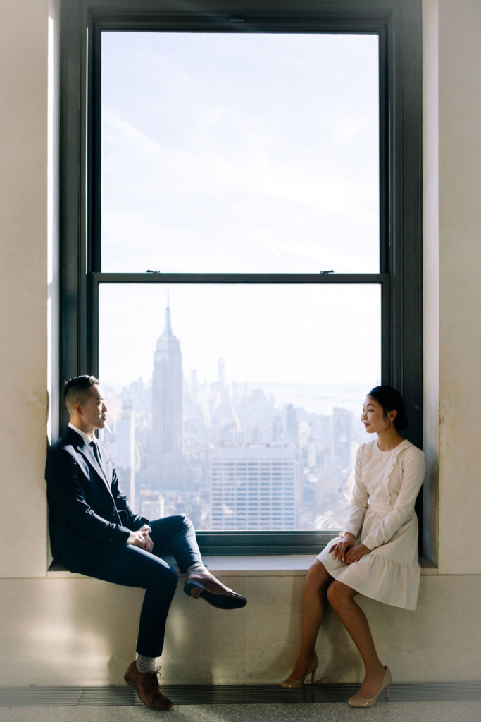 Couple by the window at Top of the Rock