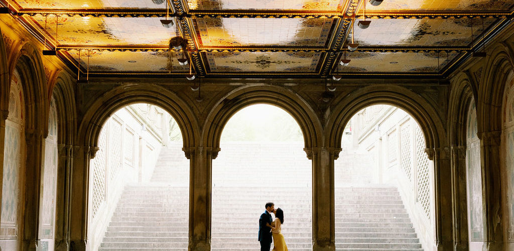 Couple kissing under the arches at Central Park
