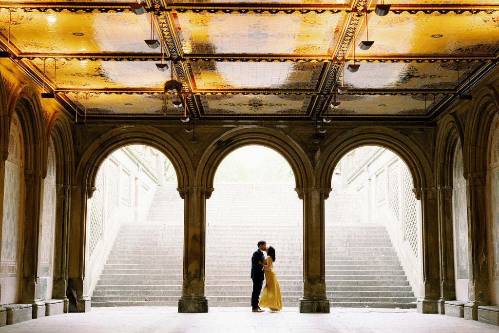 Couple kissing under the arches at Central Park
